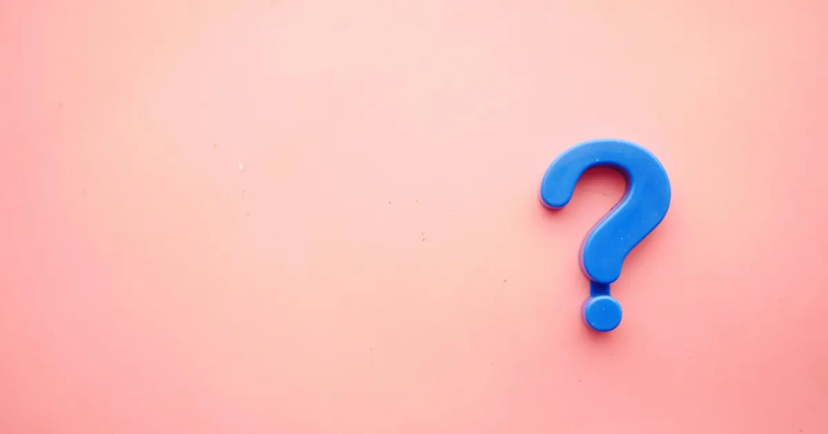 Blue question mark on a pink background