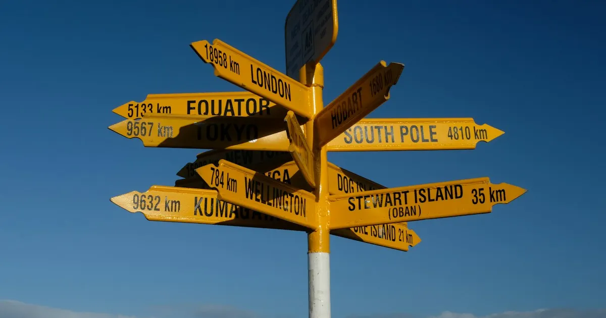 A multi-directional wooden signpost with many arrows against a blue sky